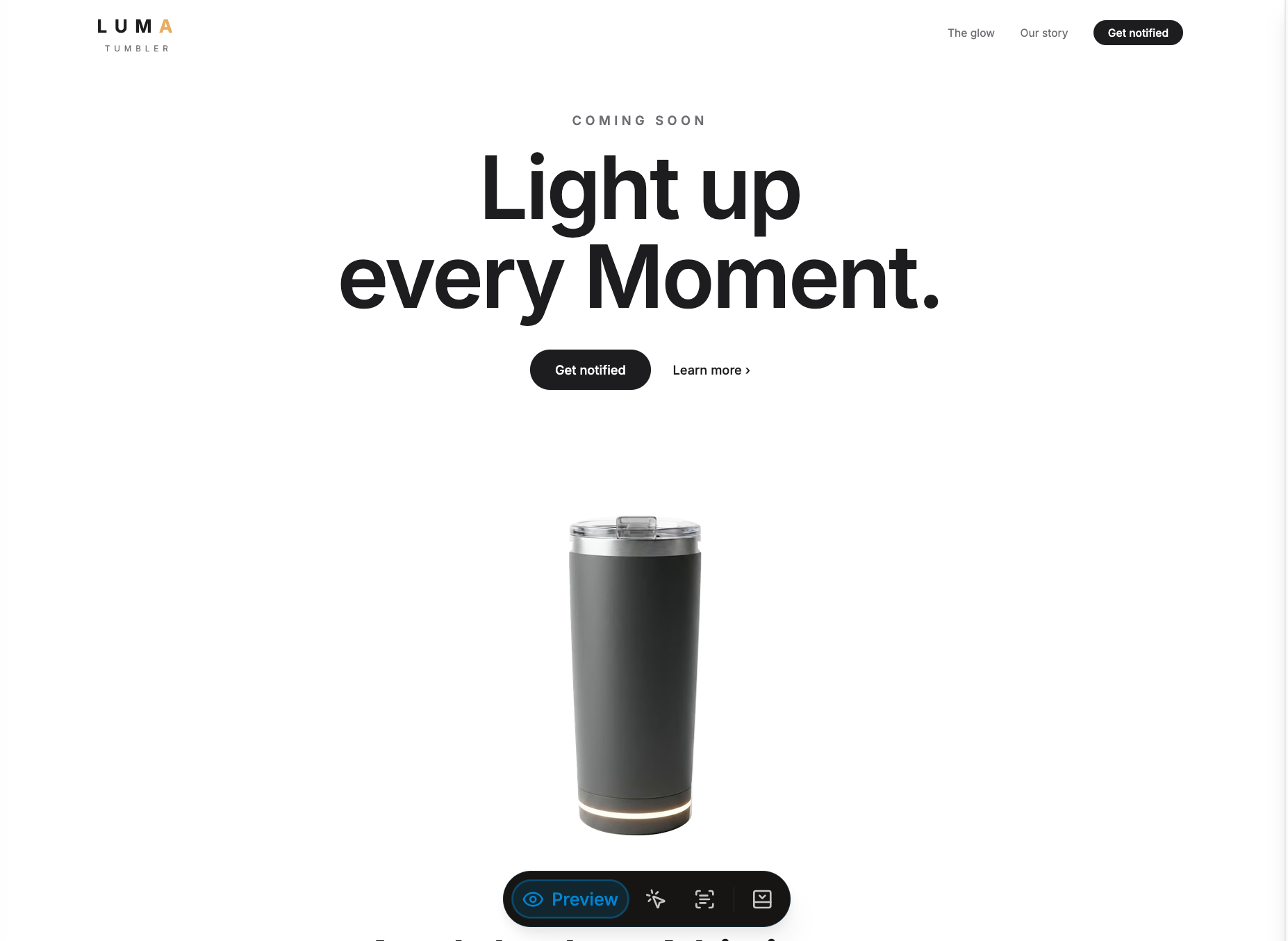 Charcoal LUMA tumbler with a clear lid and a warm ring of light around its base
